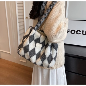 Close-up of fluffy tote bag featuring grey braided handles and color-block rhombus pattern