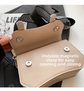 Detail of beige crossbody bag showing magnetic closure and zigzag woven shoulder strap