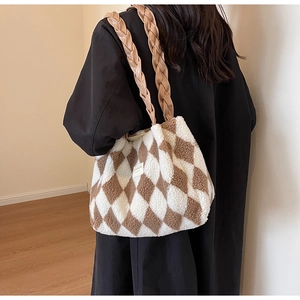 Detail of plush argyle tote bag featuring brown woven handles and soft faux fur texture