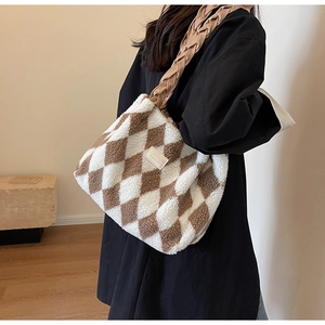 Detail of the plush checkered tote bag with woven strap and soft fuzzy texture