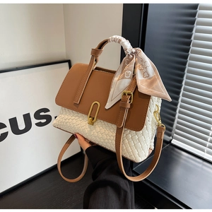 Detail of woven white leather bag with brown flap and silk scarf handle accent