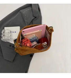 Close-up of spacious interior in brown tote bag holding tablet, umbrella and wallet