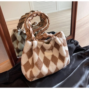 Detailed close-up of plush diamond lattice tote with brown woven leather handle texture