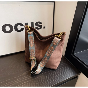 Detail of vintage brown tote bag with wide bohemian geometric pattern shoulder strap