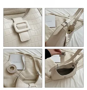 Detailed views of beige crocodile embossed shoulder bag with resin buckle and metal zipper