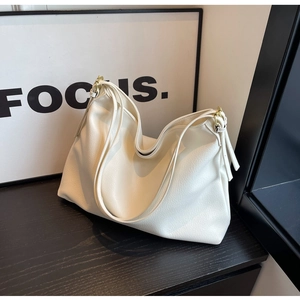 Close-up of white lychee grain leather tote with gold hardware and large capacity