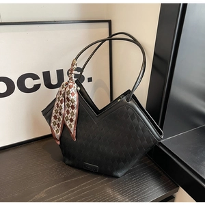 Detail of black woven texture tote bag with V-shaped opening and elegant fashion scarf