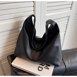 Close-up of the black lychee pattern leather texture on a spacious hobo tote bag