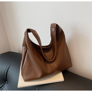 Close-up of brown pebbled leather tote bag showing high-quality texture and spacious interior