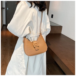 Detail of camel crescent shoulder bag with crocodile texture and square buckle