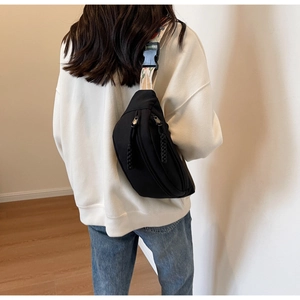 Rear view of black canvas crossbody chest bag with colorful ethnic embroidered strap
