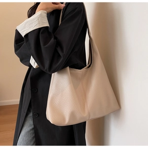Close-up of beige hobo bag showing high-quality lychee grain texture and stitching detail