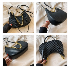 Détails du sac plissé noir avec chaîne dorée et fermeture éclair fluide de qualité