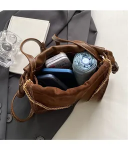 Detail view of large capacity interior for brown leather and suede bucket bag