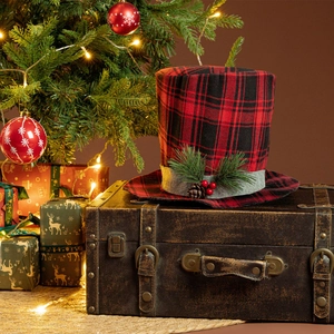 Detail of buffalo plaid Christmas tree topper hat with pine cones and berries