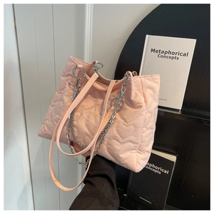 Détail du cabas en nylon rose avec matelassage en cœur, chaîne argentée et bandoulière