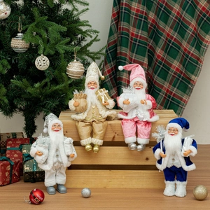 Close-up of four 12-inch Santa Claus figurines in gold, pink, silver and blue colors