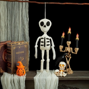 Hanging knitted skull ghost doll with pumpkin and raven Halloween decor setup