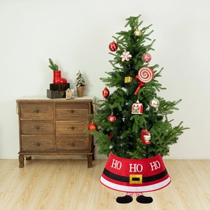 Detail of a red Santa themed Christmas tree collar featuring HO HO HO text and elf legs