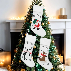Three-piece Christmas stocking set featuring Santa Claus, penguin and fox on a tree