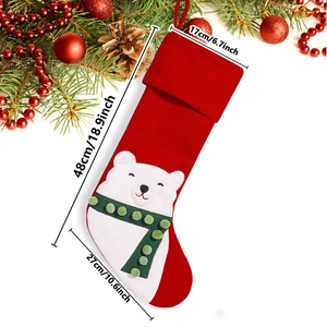 Detailed size view of red Christmas stocking with polar bear appliqué and holiday props