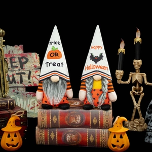 Pair of Halloween gnomes with Trick or Treat hats on vintage books for holiday decor