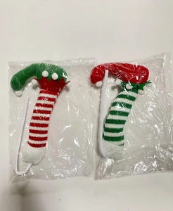 Close-up of knitted Christmas candy cane plush ornaments in festive red, white and green