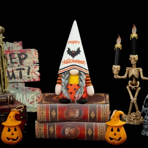 Halloween gnome doll with Happy Halloween hat on vintage books for holiday decoration