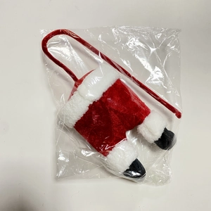 Detail showing red velvet Santa pants holiday decoration with white plush trim and long strap