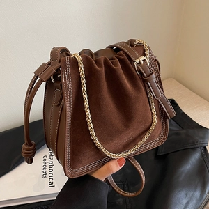 Retro brown suede bucket bag with white stitching and gold chain detail for women