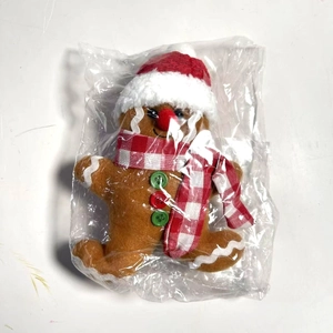 Dettaglio dell'omino di pan di zenzero peluche con cappello e sciarpa di Natale