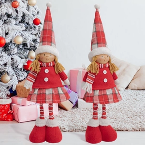Detail of Christmas girl elf dolls with plaid hats in festive holiday home setting