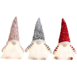 Three glowing Christmas gnomes with sequined hats and warm LED lights in a festive set