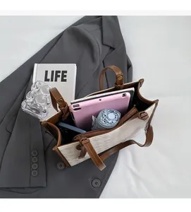 Spacious interior of beige quilted tote bag showing tablet and daily essentials