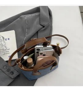 Top view of blue denim bucket bag interior showing capacity for phones and a wallet