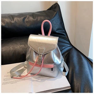 Détail d'un mini sac à dos argenté métallisé avec poignée rose et texture PU plissée