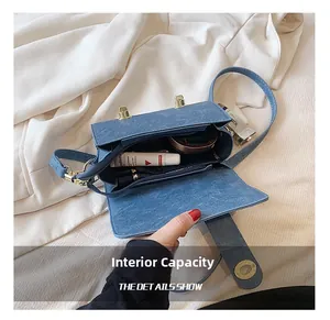 Internal capacity of blue denim crossbody bag showing main storage space