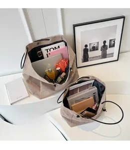 Detail of canvas tote bags showing spacious interior compartments for laptop and essentials