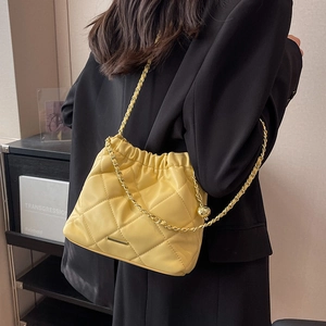 Quilted yellow shoulder bag with gold chain strap and drawstring closure for women