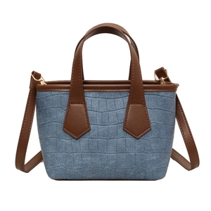 Blue crocodile pattern mini tote bag with brown leather handles and adjustable shoulder strap