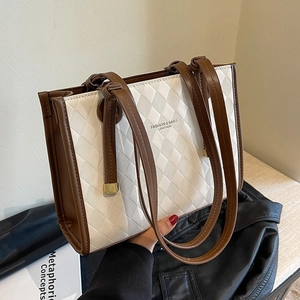 White quilted tote bag with brown leather trim and large capacity for women