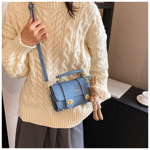 Blue textured leather crossbody bag with gold locks and a cute brown rabbit charm detail