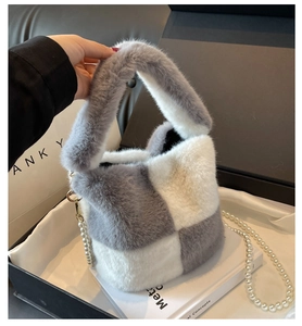 Detail of gray and white checkered plush bucket bag with pearl chain and gold hook