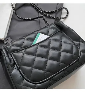 Detail view of the black quilted shoulder bag featuring a functional back slip pocket