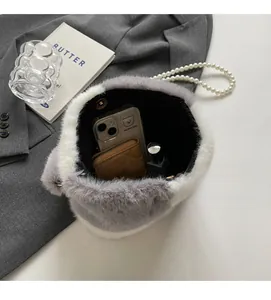 Interior view of plush faux fur handbag showing spacious storage for phone and lipstick