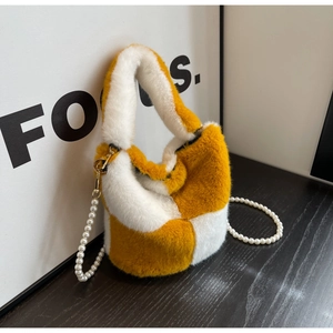 Detail of yellow checkerboard plush bucket bag with soft faux fur and pearl strap