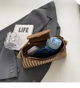 Internal capacity of brown houndstooth bag showing space for phone and umbrella