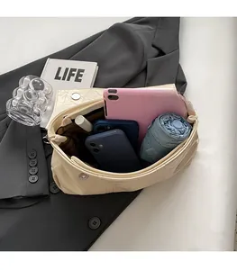 Top view of cream white crossbody bag interior showing spacious storage for tablet and umbrella