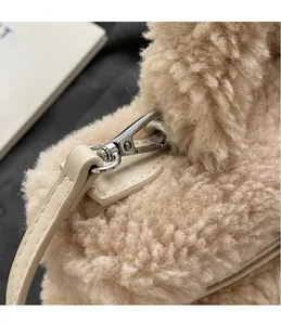 Détail du crochet en métal argenté et fausse fourrure marron clair du sac seau