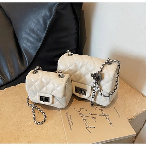 Detailed view of quilted leather chain bags with metallic twist locks in two sizes